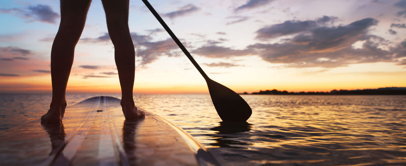 Shop Cape Cod Salty Vibes merch at Cape Mercantile. Woman paddle boarding on a Cape Cod kettle pond MA.