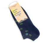 Navy blue sock with green turtle designs that support marine life and healthy oceans