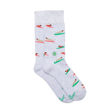 Flat lay of Surfing Pups organic cotton socks that save dogs showing the full knitted surfing pup design.